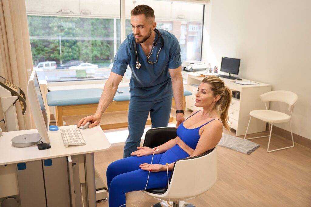 Woman sitting on chair with sensors connected to her hands