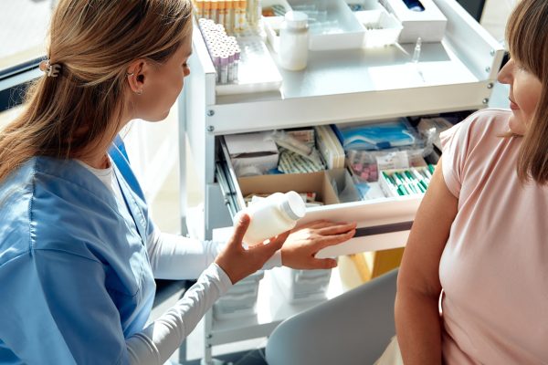 A Healthcare Professional is Providing Prescription Medication to a Patient in Need